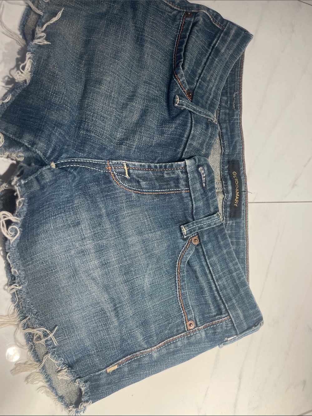 Distressed Denim Cutoff Shorts in Mid Blue